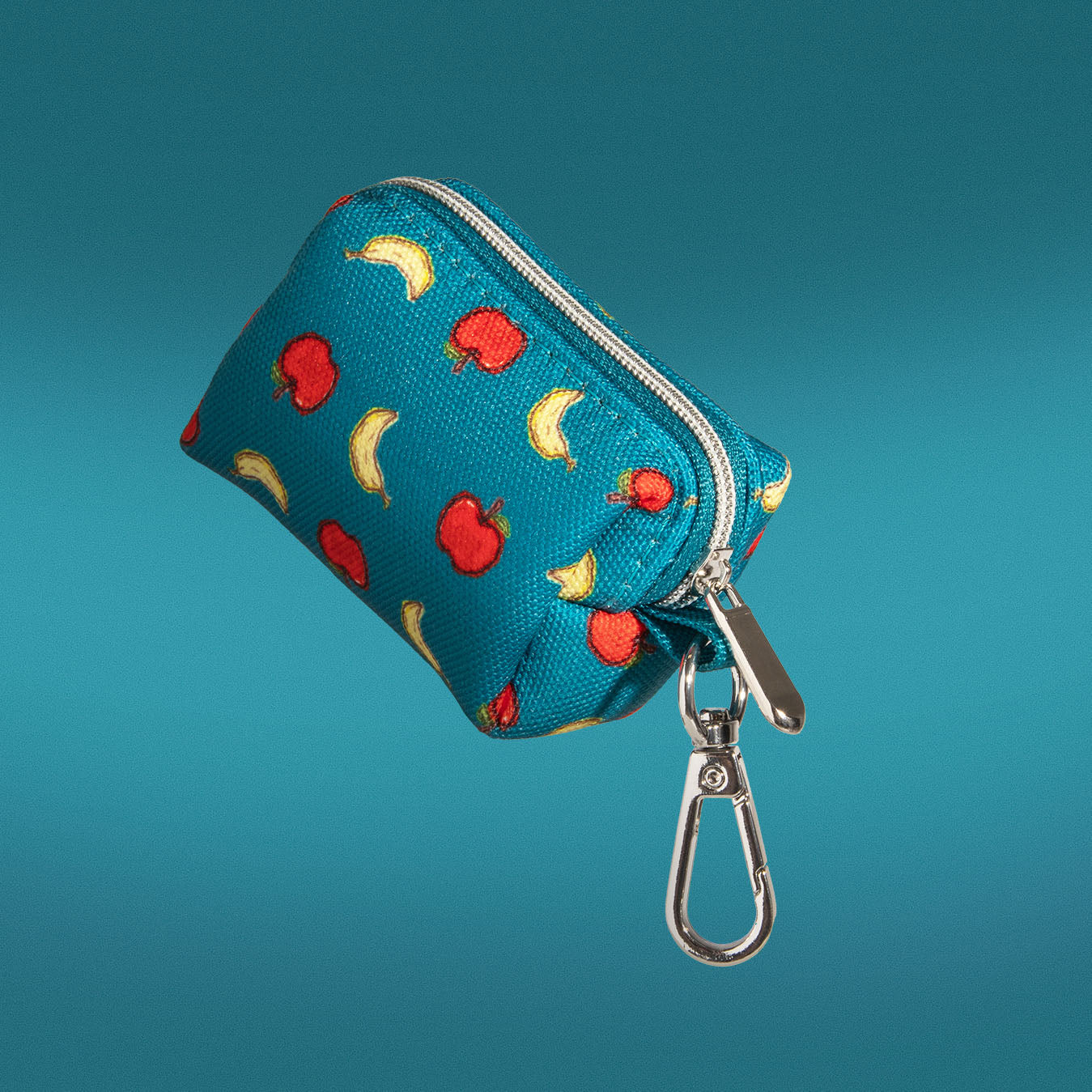 Banapples waste bag holder in teal with apple and banana print